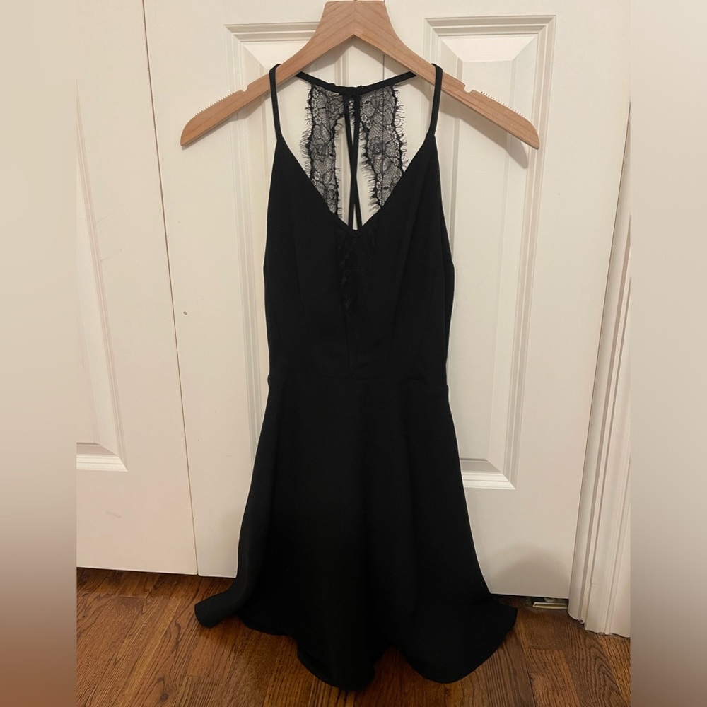 Black mini dress with lace in front and on straps. Never worn perfect condition!